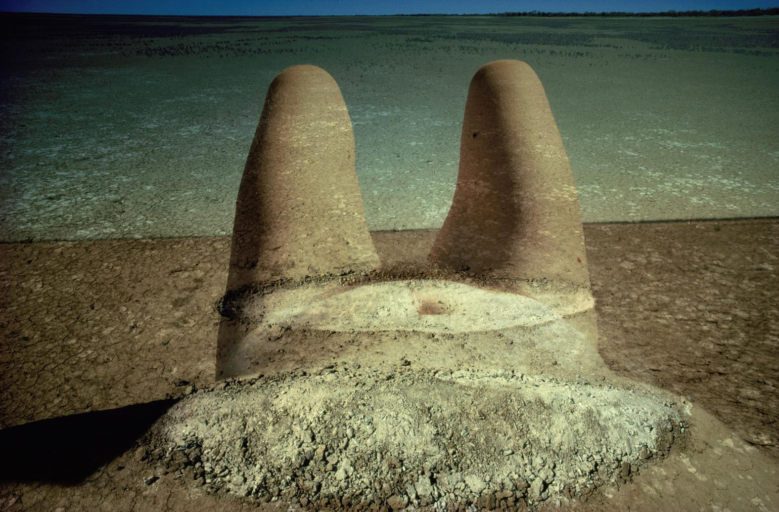 womans body in the sand with water covering