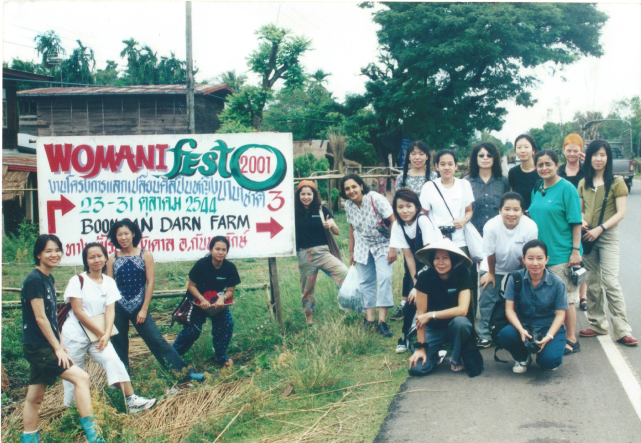 2001 Womanifesto Workshop participants with sign