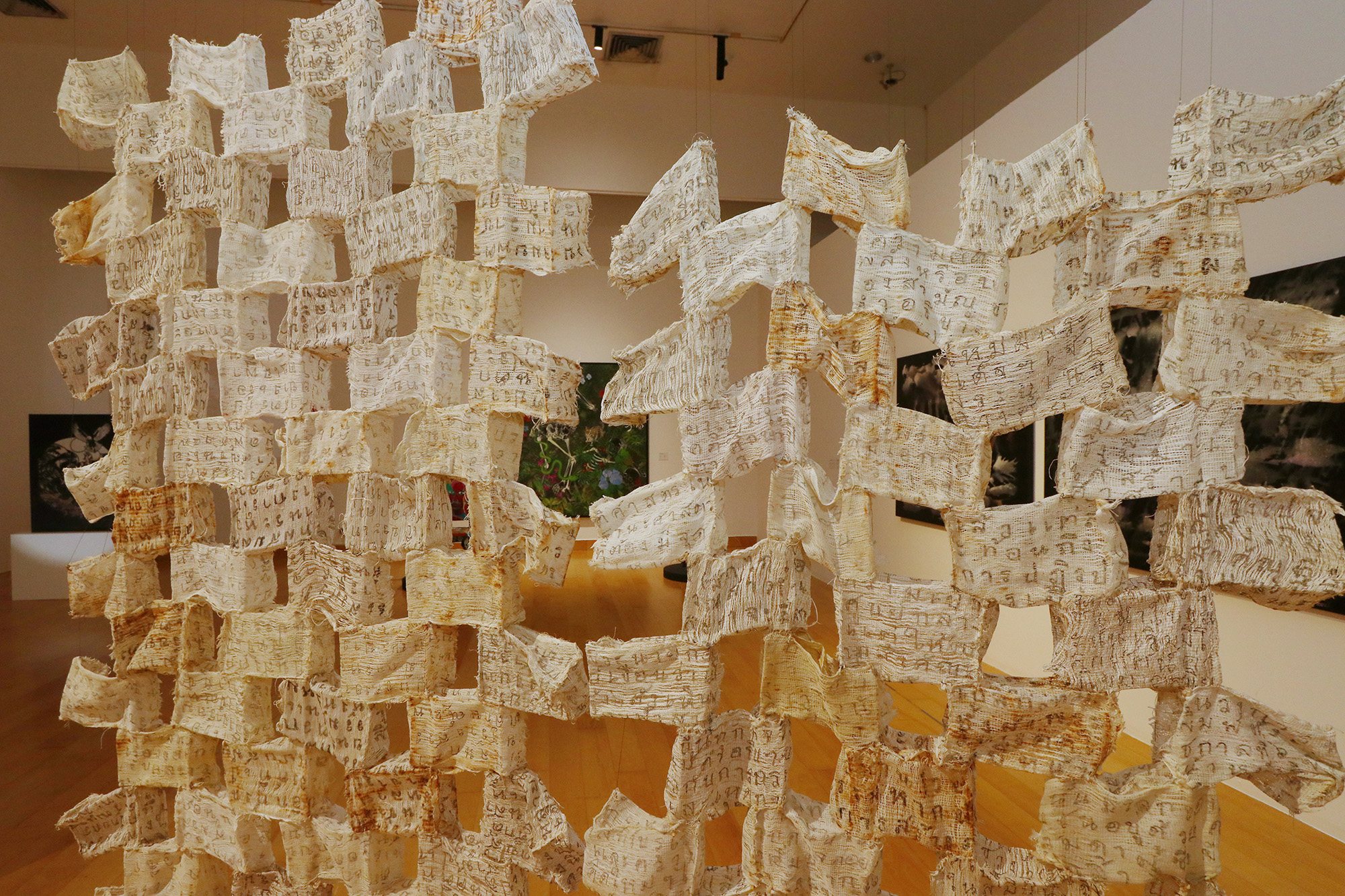 fabric hanging artwork with inked letters