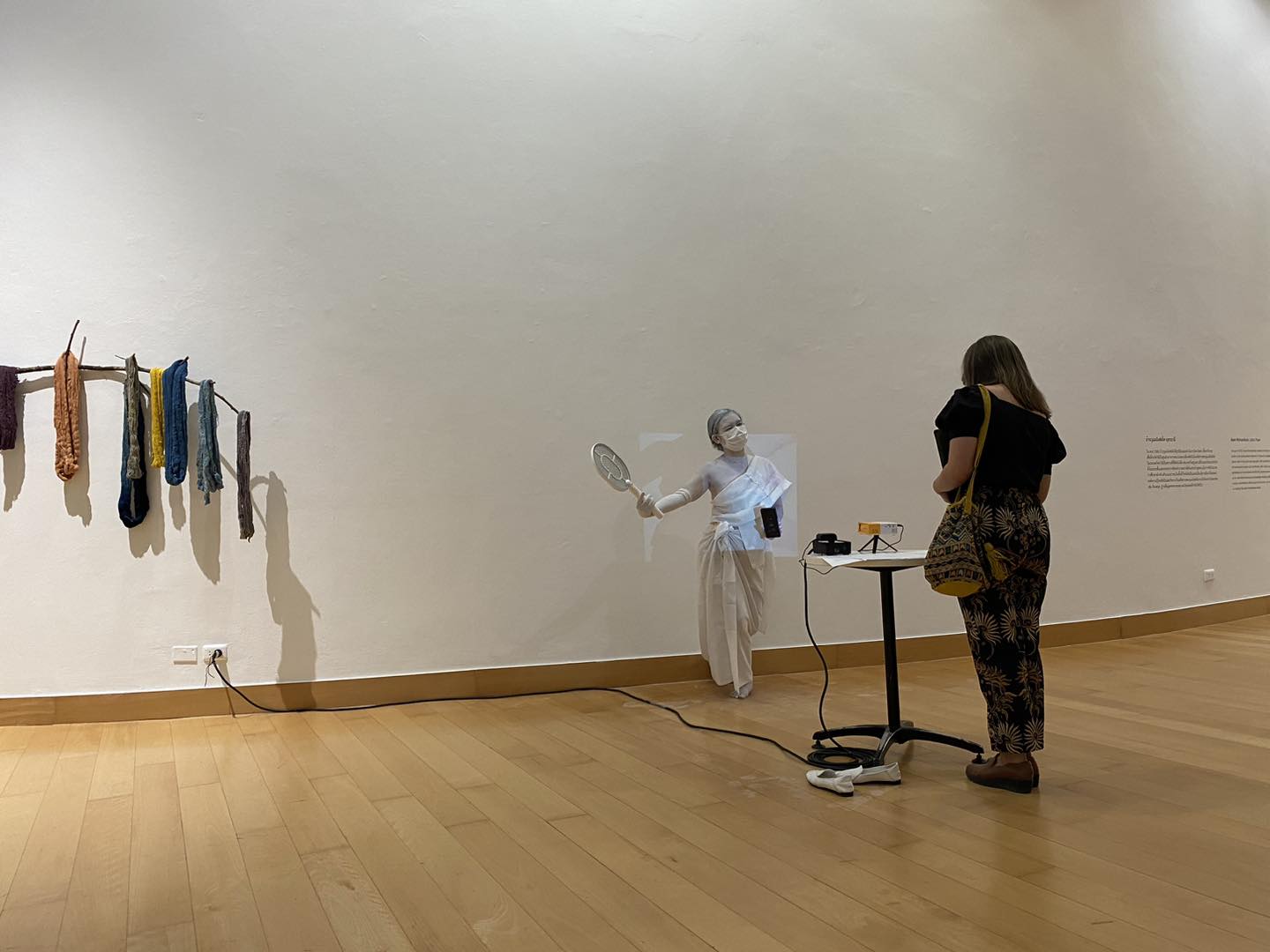 performance, woman dressed in white with a fan