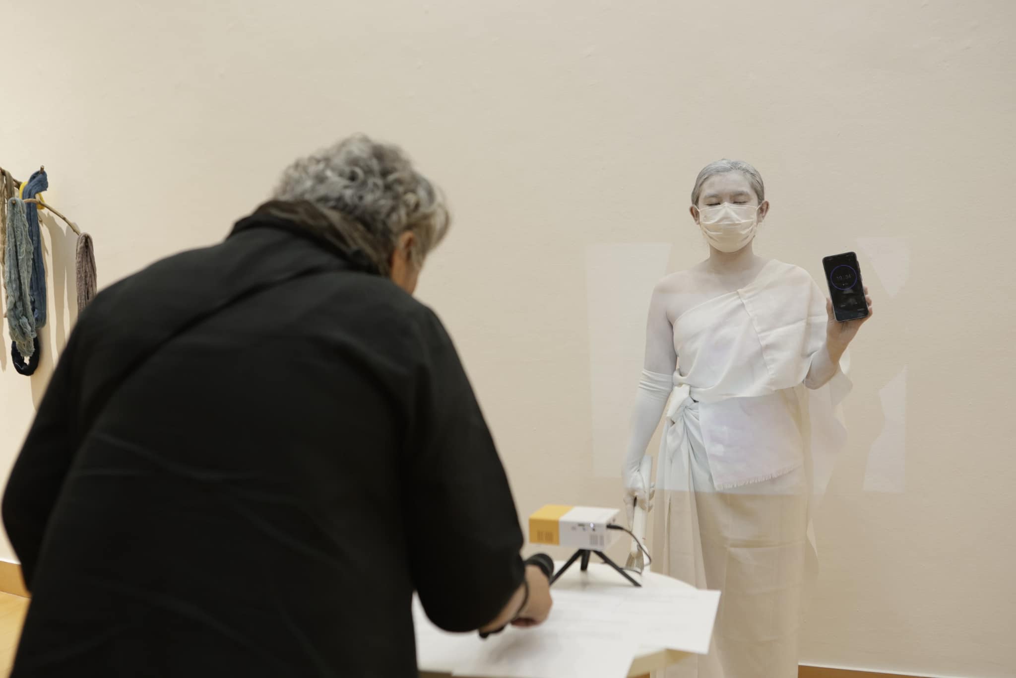 woman in white holding phone