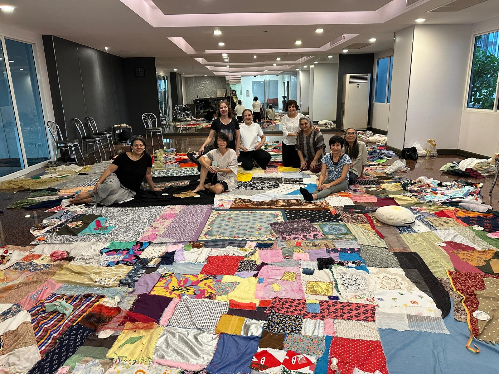 Process of artists gathered to join WeMend pieces together